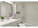 Bathroom features modern white fixtures, subway tile, and a vanity with a sleek mirror, creating a clean, stylish space at 10310 E Jewell Ave # 55, Aurora, CO 80247