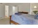 Comfortable bedroom features a wooden bed frame and dresser, providing a peaceful space with carpet flooring at 10310 E Jewell Ave # 55, Aurora, CO 80247