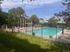 Community pool and clubhouse surrounded by lush green landscaping at 10310 E Jewell Ave # 55, Aurora, CO 80247