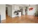 Open floor plan with hardwood floors and adjacent dining and kitchen areas at 10310 E Jewell Ave # 55, Aurora, CO 80247