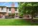 Charming brick townhouse with a well-maintained lawn and mature trees at 10310 E Jewell Ave # 55, Aurora, CO 80247