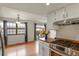 Bright kitchen featuring stainless steel appliances and warm countertops, open to a cozy dining area and outdoor view at 10310 E Jewell Ave # 55, Aurora, CO 80247