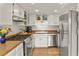 Well-lit kitchen with stainless steel appliances, white cabinets, and warm countertops, offering a functional cooking space at 10310 E Jewell Ave # 55, Aurora, CO 80247