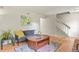 Bright living room with hardwood floors, neutral walls, and a staircase at 10310 E Jewell Ave # 55, Aurora, CO 80247