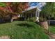 A view of the home's sunroom surrounded by greenery in the backyard at 2427 S Eldridge Ct, Lakewood, CO 80228