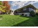 Well maintained lawn with mature trees in the backyard and a view of the house at 2427 S Eldridge Ct, Lakewood, CO 80228