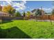 Lush backyard with a wooden fence and mature trees providing ample privacy at 2427 S Eldridge Ct, Lakewood, CO 80228