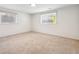 Unfurnished basement area with carpet and two windows at 2427 S Eldridge Ct, Lakewood, CO 80228