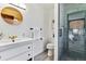 Bathroom boasting modern fixtures and a sleek glass-enclosed shower with unique tile at 2427 S Eldridge Ct, Lakewood, CO 80228