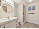 Finished bathroom with modern fixtures, lighting, and stylish vanity at 2427 S Eldridge Ct, Lakewood, CO 80228