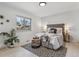 Bright bedroom with large window, stylish rug, and comfortable furnishings at 2427 S Eldridge Ct, Lakewood, CO 80228