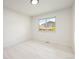 Bright bedroom features a large window offering a view of the neighborhood at 2427 S Eldridge Ct, Lakewood, CO 80228