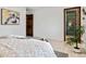 Bedroom showcasing a dark wood door and a glass shower at 2427 S Eldridge Ct, Lakewood, CO 80228