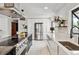 Spacious kitchen features stainless appliances, black countertops and white hardwood floors at 2427 S Eldridge Ct, Lakewood, CO 80228