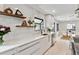 Bright kitchen design with white cabinets, stainless steel appliances and hardwood floors at 2427 S Eldridge Ct, Lakewood, CO 80228