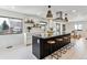 Modern kitchen featuring a large island with bar seating, contemporary lighting, and stainless steel appliances at 2427 S Eldridge Ct, Lakewood, CO 80228