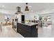 Open kitchen featuring a large island, modern appliances, and seamless transition to the living and dining areas at 2427 S Eldridge Ct, Lakewood, CO 80228