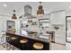 Island kitchen with bar stool seating, stainless appliances and modern lighting at 2427 S Eldridge Ct, Lakewood, CO 80228