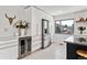 Sleek modern kitchen with white cabinets, stainless steel refrigerator, and stylish built-in wine cooler at 2427 S Eldridge Ct, Lakewood, CO 80228