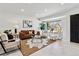 Inviting living room with lots of natural light, white floors, stylish furniture, and sleek décor at 2427 S Eldridge Ct, Lakewood, CO 80228