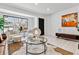 Sunlit living room featuring a view to the outside, white floors, modern furniture, and sophisticated decorations at 2427 S Eldridge Ct, Lakewood, CO 80228