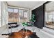 Cozy sunroom featuring black brick wall and two black chairs at 2427 S Eldridge Ct, Lakewood, CO 80228