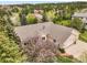 Aerial view of a home showcasing its mature trees, surrounding neighborhood, and well-maintained landscaping at 1590 Longview Cir, Monument, CO 80132
