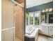Bathroom featuring tub and shower combination, vanity with double sinks, and a window at 1590 Longview Cir, Monument, CO 80132