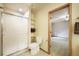 Bathroom featuring a walk-in shower, a toilet, and an open doorway to another room at 1590 Longview Cir, Monument, CO 80132