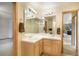 Bathroom featuring a dual sink vanity with a large mirror and recessed lighting above at 1590 Longview Cir, Monument, CO 80132