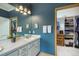 Bathroom with a closet, vanity with mirror and sink, and bright lighting at 1590 Longview Cir, Monument, CO 80132
