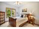Bedroom with a wooden bed frame, a side table, and a window for natural light at 1590 Longview Cir, Monument, CO 80132