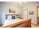 Bedroom with a wooden bed frame, a side table, and a window for natural light at 1590 Longview Cir, Monument, CO 80132