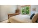 Bedroom with a wooden bed frame, a storage unit and a window for natural light at 1590 Longview Cir, Monument, CO 80132