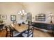 Spacious dining room featuring hardwood floors, a decorative chandelier, and stylish furnishings at 1590 Longview Cir, Monument, CO 80132