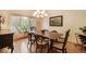 Bright dining room features a classic chandelier, large window, and elegant hardwood floors perfect for entertaining at 1590 Longview Cir, Monument, CO 80132