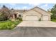 Inviting exterior with a spacious driveway and a two-car garage, complemented by beautiful landscaping at 1590 Longview Cir, Monument, CO 80132