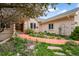 Exterior view of a home with a well-manicured front yard and colorful landscaping at 1590 Longview Cir, Monument, CO 80132