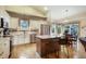 Bright, modern kitchen with white cabinets, stainless steel appliances, island seating, and a dining nook at 1590 Longview Cir, Monument, CO 80132