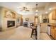 Living room features fireplace, ceiling fan, mini-bar, and open floor plan at 1590 Longview Cir, Monument, CO 80132