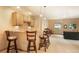 Features bar with seating, recessed lighting, and view of adjacent living room at 1590 Longview Cir, Monument, CO 80132