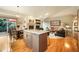 Spacious living area boasts a central island, fireplace, and seamless flow to the outdoor deck for relaxed living at 1590 Longview Cir, Monument, CO 80132