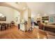 Open-concept living space with hardwood floors, a dining area, and a view of the cozy living room with a fireplace at 1590 Longview Cir, Monument, CO 80132
