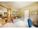 Well-lit office featuring a comfortable sofa and view through glass doors into the living room at 1590 Longview Cir, Monument, CO 80132