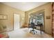 Cozy office space with ample natural light, built-in bookshelves, and comfortable seating at 1590 Longview Cir, Monument, CO 80132