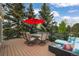 Spacious outdoor deck with comfortable seating and lush greenery, perfect for relaxation and entertaining at 1590 Longview Cir, Monument, CO 80132