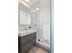 Modern bathroom features a sleek gray vanity and tiled glass shower with a rainfall shower head at 1922 E 18Th Ave, Denver, CO 80206