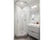 Clean and modern bathroom with white herringbone tile in shower and updated vanity with storage at 1922 E 18Th Ave, Denver, CO 80206