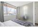 Bright bedroom with large window, frosted glass feature and neutral decor at 1922 E 18Th Ave, Denver, CO 80206