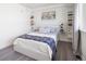 Cozy bedroom featuring soft bedding, custom shelving, and ample natural light at 1922 E 18Th Ave, Denver, CO 80206